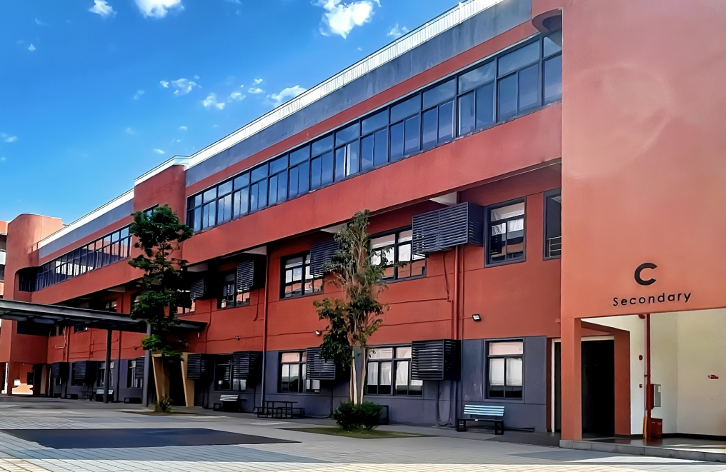 A group of people walking down the street with backpacks and books.